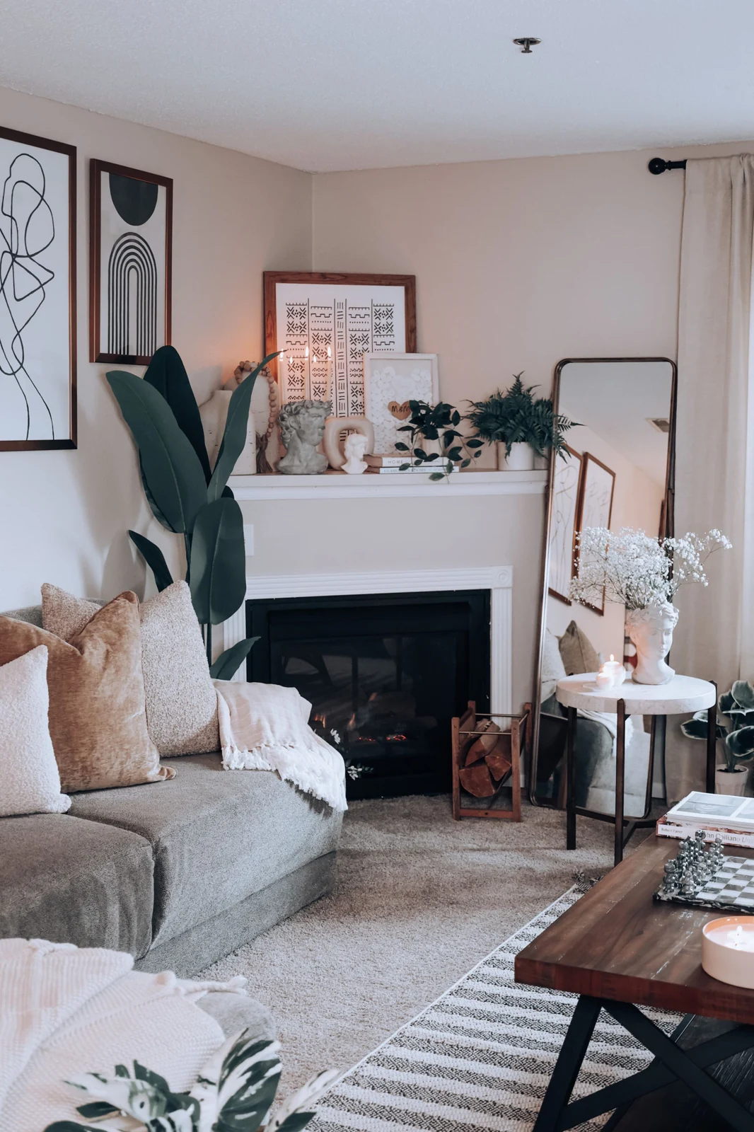 White mantel fireplace in a softly furnished living room